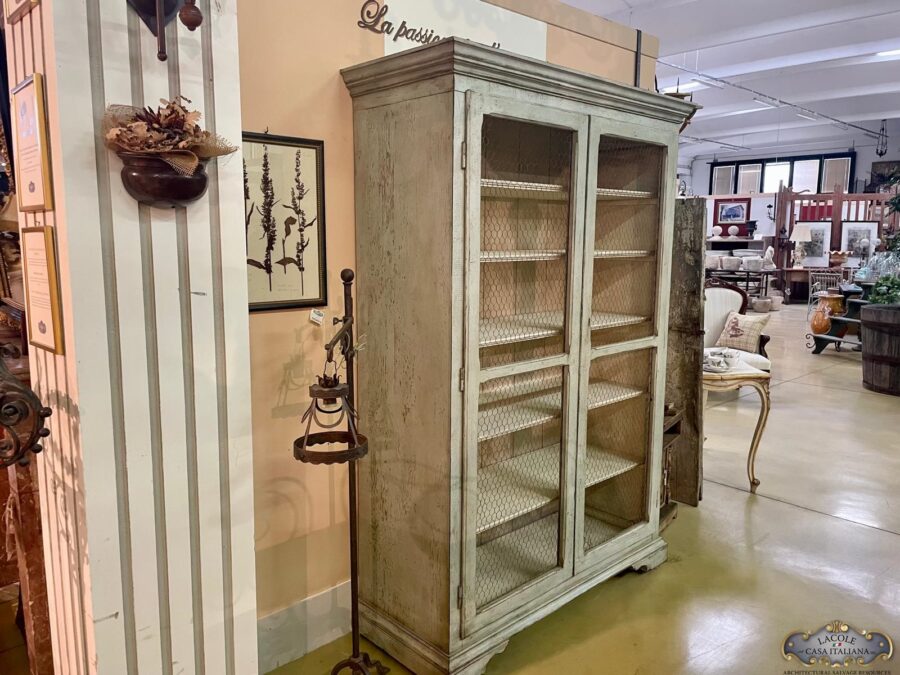 Pantry cabinet made of antique wood patinated in the colors of green sage.